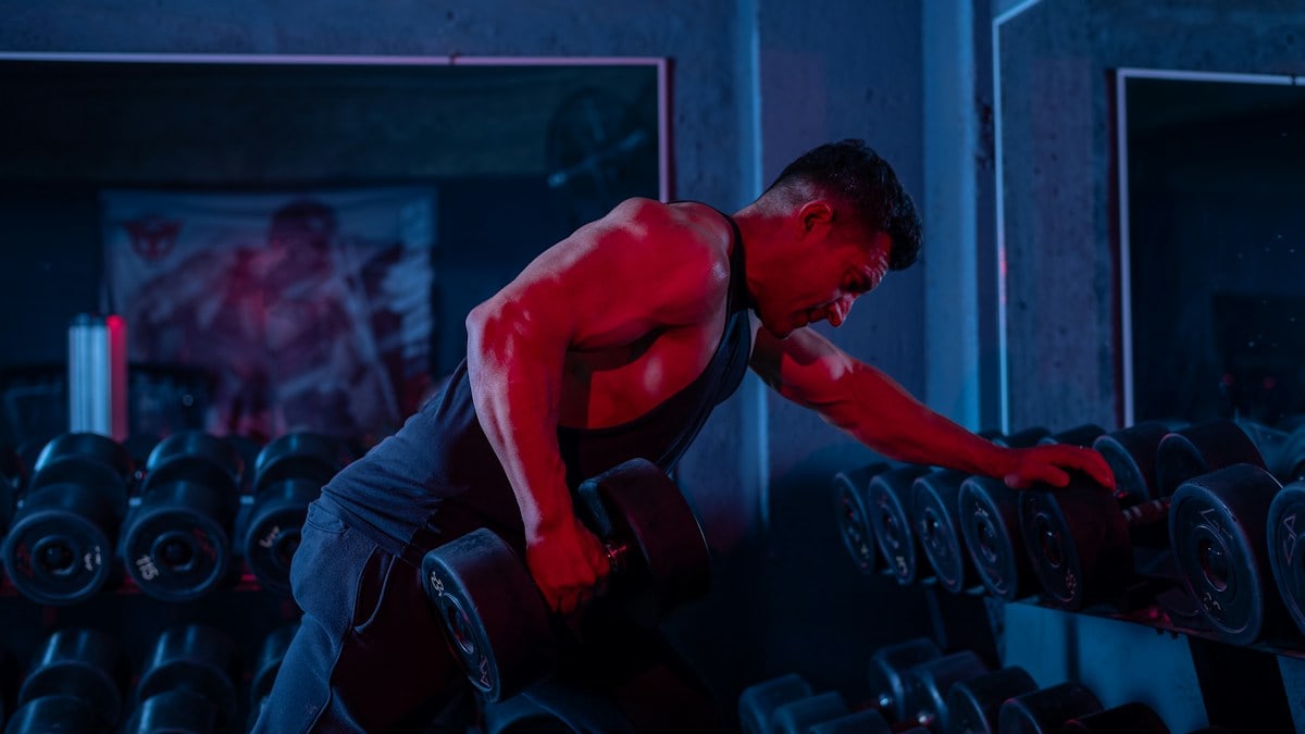 A man working out with a barbell in a gym